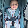 baby, smiling, stroller, child, outdoor, happy, infant, clothing, seatbelt, cute, person, toddler, jumpsuit, tie_dye, transportation, wheel, daylight, safety, cute_expression, baby_girl_or_boy
