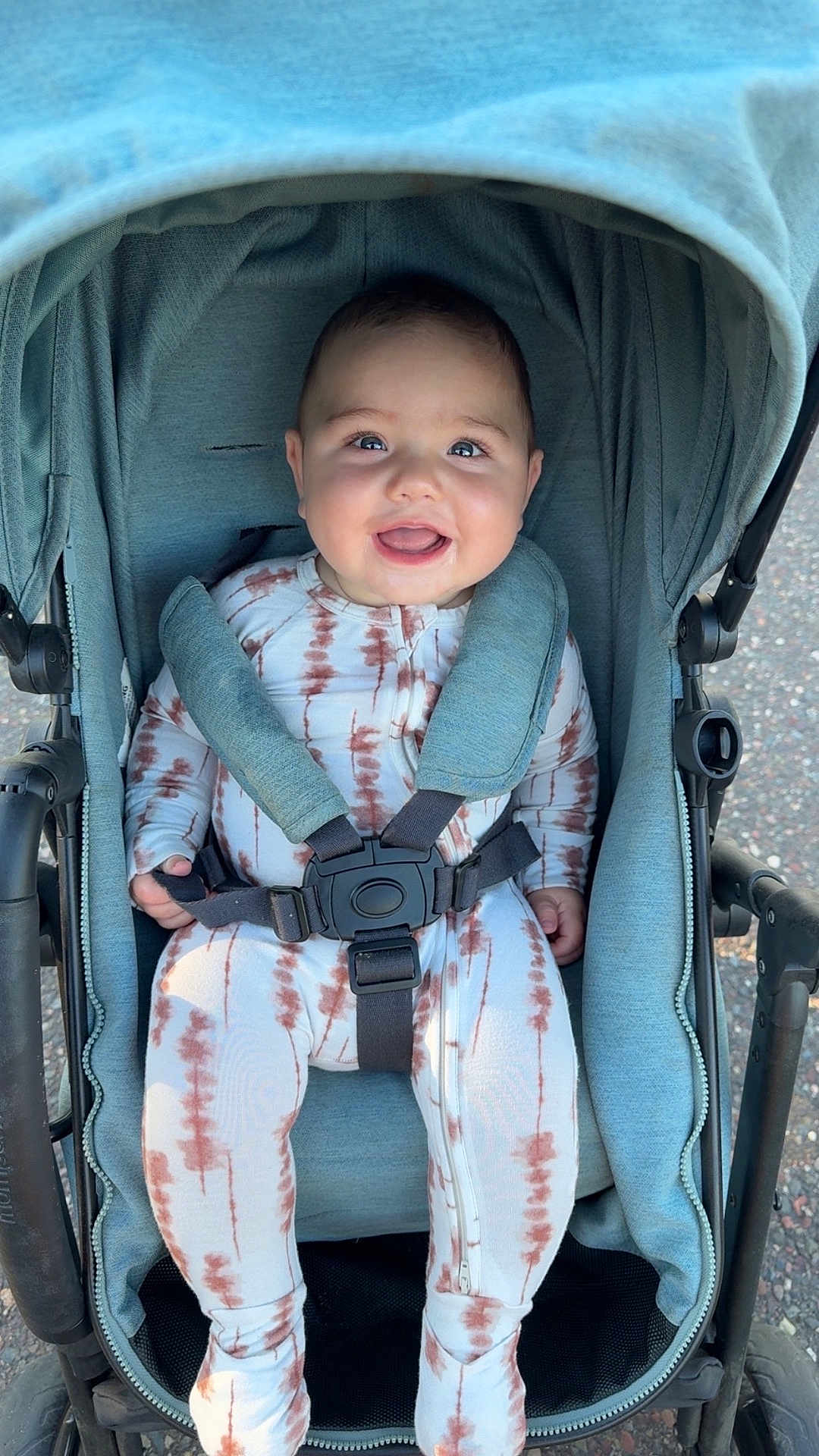 Weston joined the competition — help win amazing prizes! baby, smiling, stroller, child, outdoor, happy, infant, clothing, seatbelt, cute, person, toddler, jumpsuit, tie_dye, transportation, wheel, daylight, safety, cute_expression, baby_girl_or_boy
