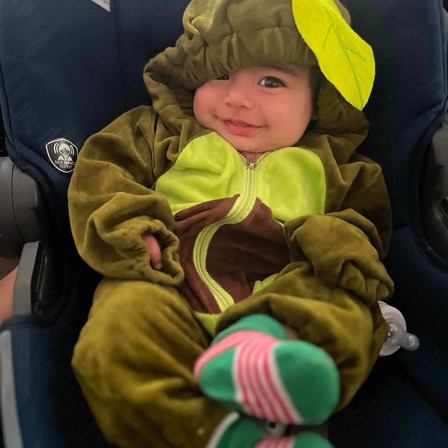 Kenaz joined the competition — help win amazing prizes! baby, car_seat, child, clothing, costume, cozy, cute, green, happy, hood, indoors, infant, leaf, pacifier, person, portrait, seat, smile, socks, young