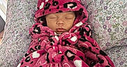 Ivory is registered to the contest to win money with this photo: baby, sleeping, blanket, hooded, pink, leopard_print, heart_pattern, pillow, floral, patterned, cozy, resting, infant, cute, soft, fabric, indoors, child, peaceful, portrait
