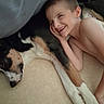 child, dog, smiling, sleeping, blanket, indoor, cozy, friendship, comfort, happy, resting, cute, animal, human, bedroom, skin, face, paw, napping, relaxing