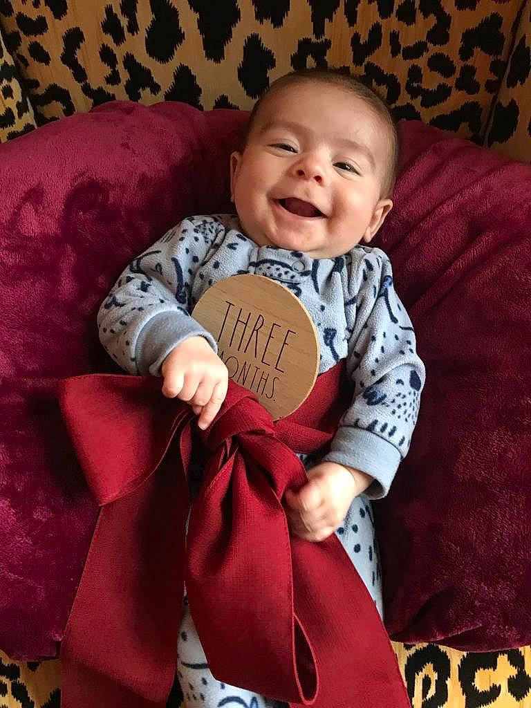 Giovanni joined the competition — help win amazing prizes! baby, baby_toddler_clothing, cheek, child, comfort, eye, face, happy, head, human, linens, person, pink, red, sitting, skin, sleeve, smile, textile, thigh