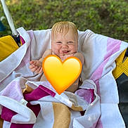 Mia is registered to the contest to win money with this photo: baby, child, colorful, cute, fun, grass, happy, outdoor, person, playground, relaxing, seat, smile, striped, summer, swing, towel, wet_hair, wrapped, young_child