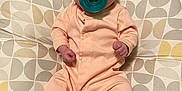 Mia is registered to the contest to win money with this photo: baby, bed, bodypart, clothing, couch, cushion, face, finger, footwear, furniture, head, homedecor, hosiery, pants, person, photography, portrait, shoe, sitting, sock