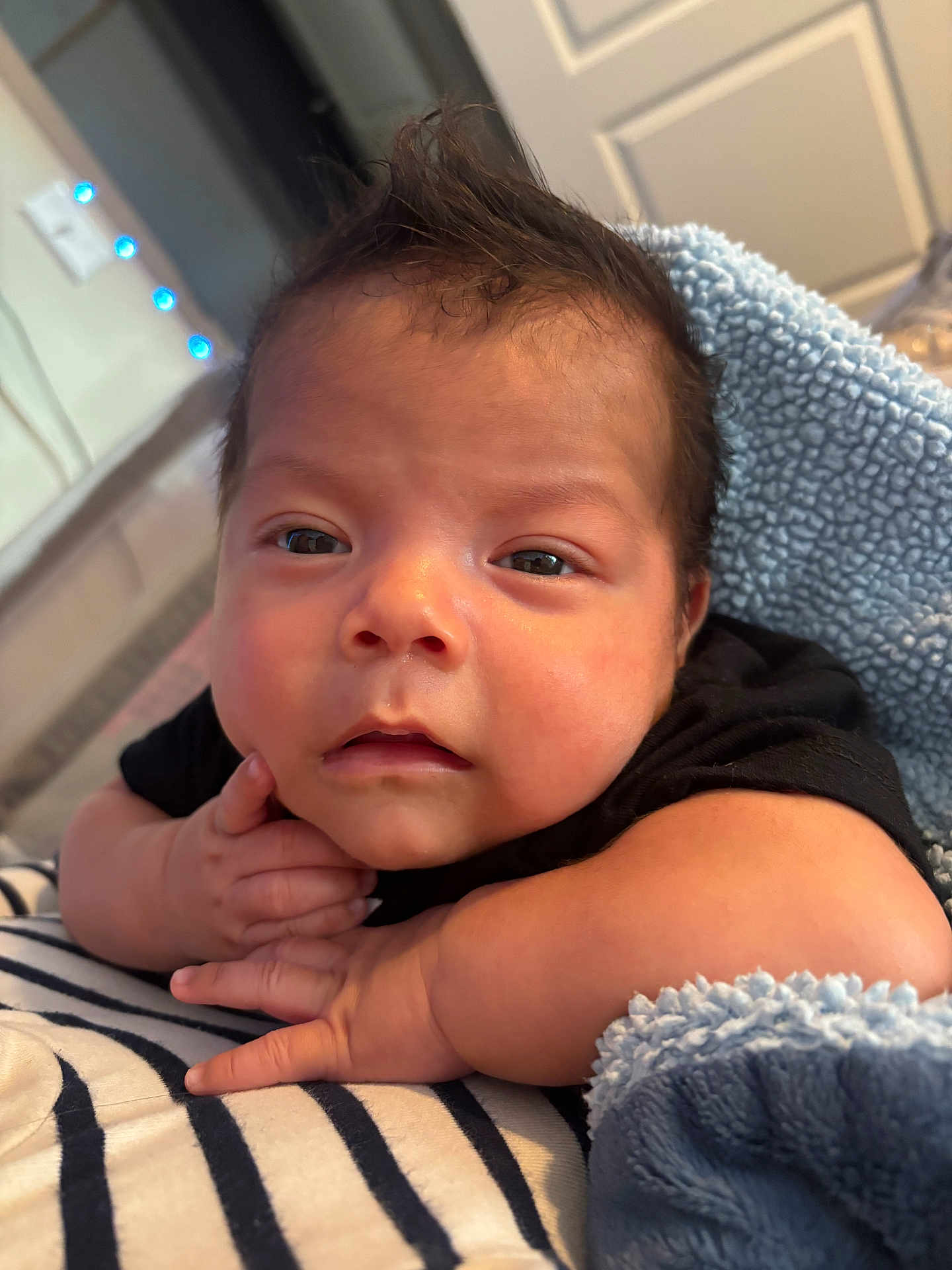 Ivan is registered to the contest to win money with this photo: baby, infant, face, expression, blanket, striped, hand, skin, hair, sleepy, closeup, indoors, soft, comfort, cuddly, newborn, person, young, cute, portrait