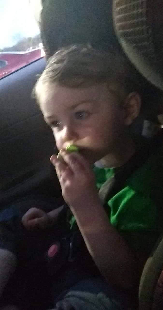 Octavious is registered to the contest to win money with this photo: biting, child, comfort_food, drinking, eating, family_car, finger_food, food, fruit, fun, gesture, grass, happy, jaw, junk_food, luxury_vehicle, nose, person, thumb, toddler