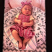 Delilah P. joined the competition — help win amazing prizes! baby, sleeping, pink, headband, floral, cushion, blanket, pattern, infant, peaceful, cozy, cute, child, newborn, resting, soft, clothing, indoors, portrait, relaxation