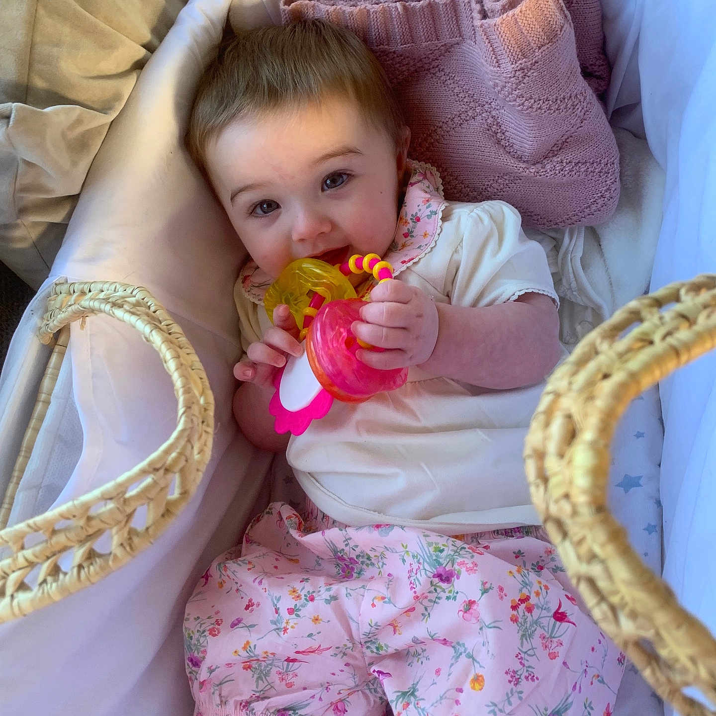 Ava-Mae joined the competition — help win amazing prizes! baby, bassinet, blanket, child, comfort, cute, face, floral_pattern, indoors, infant, pink_clothing, portrait, relaxed, resting, sleeping_area, small_hands, smiling, soft_lighting, teething_toy, toy