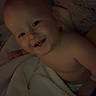 Willie joined the competition — help win amazing prizes! baby, child, infant, smiling, toothy_smile, face, portrait, lying_down, bed, blanket, bedding, cozy, indoors, dim_lighting, warm_tones, bare_shoulders, diaper, happy, sleepy, close_up