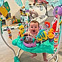 Avalyn is registered to the contest to win money with this photo: baby, jumper, toy, smiling, indoor, floor, playroom, colorful, child, furniture, plastic, seat, person, happy, living_room, playtime, infant, home, foot, expression