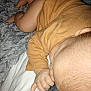 baby, infant, blanket, thumb_sucking, sleeping, soft_texture, mustard_clothing, hand, head, skin, lying_down, cozy, indoors, fabric, crawling_position, child, toddler, warm, comfort, nap_time