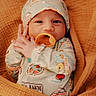 baby, infant, pacifier, blanket, hat, onesie, wrapped, cozy, cute, child, newborn, sleepwear, comfortable, soft, portrait, indoor, cute_expression, small_hands, adorable, warm