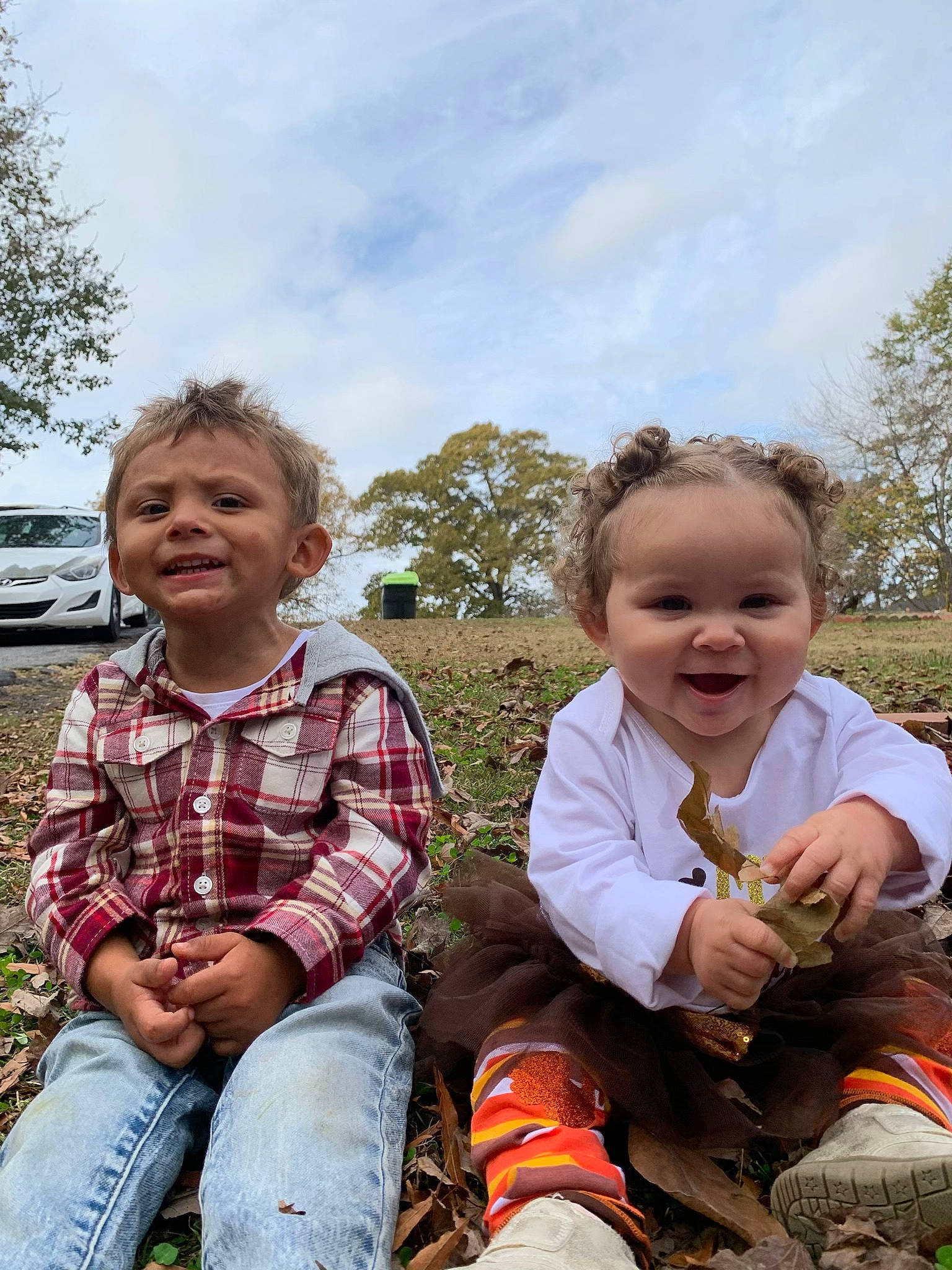 Kyrie is registered to the contest to win money with this photo: boot, child, cloud, event, face, fun, grass, happy, joy, landscape, leisure, people, people_in_nature, person, plaid, plant, shoe, sky, smile, sneakers