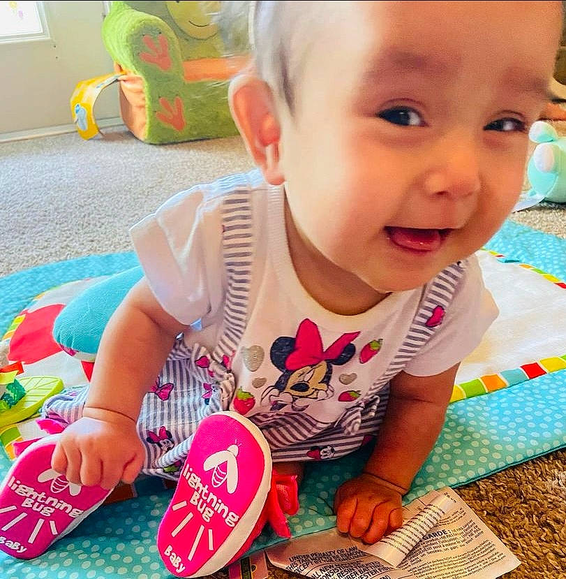 Emily is registered to the contest to win money with this photo: baby, baby_toddler_clothing, cheek, cool, face, finger, grass, green, hand, happy, head, iris, nose, person, pink, product, skin, sleeve, smile, t_shirt