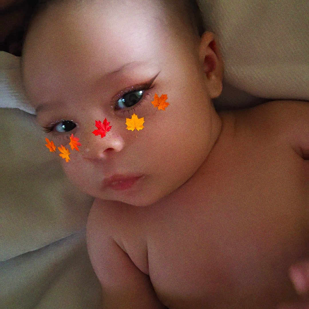 Mary joined the competition — help win amazing prizes! baby, infant, child, face, eyes, portrait, close_up, autumn_leaves, leaf_filter, digital_effect, bare_shoulders, lying_down, blanket, cozy, indoor, soft_lighting, curious, natural_expression, photography, human