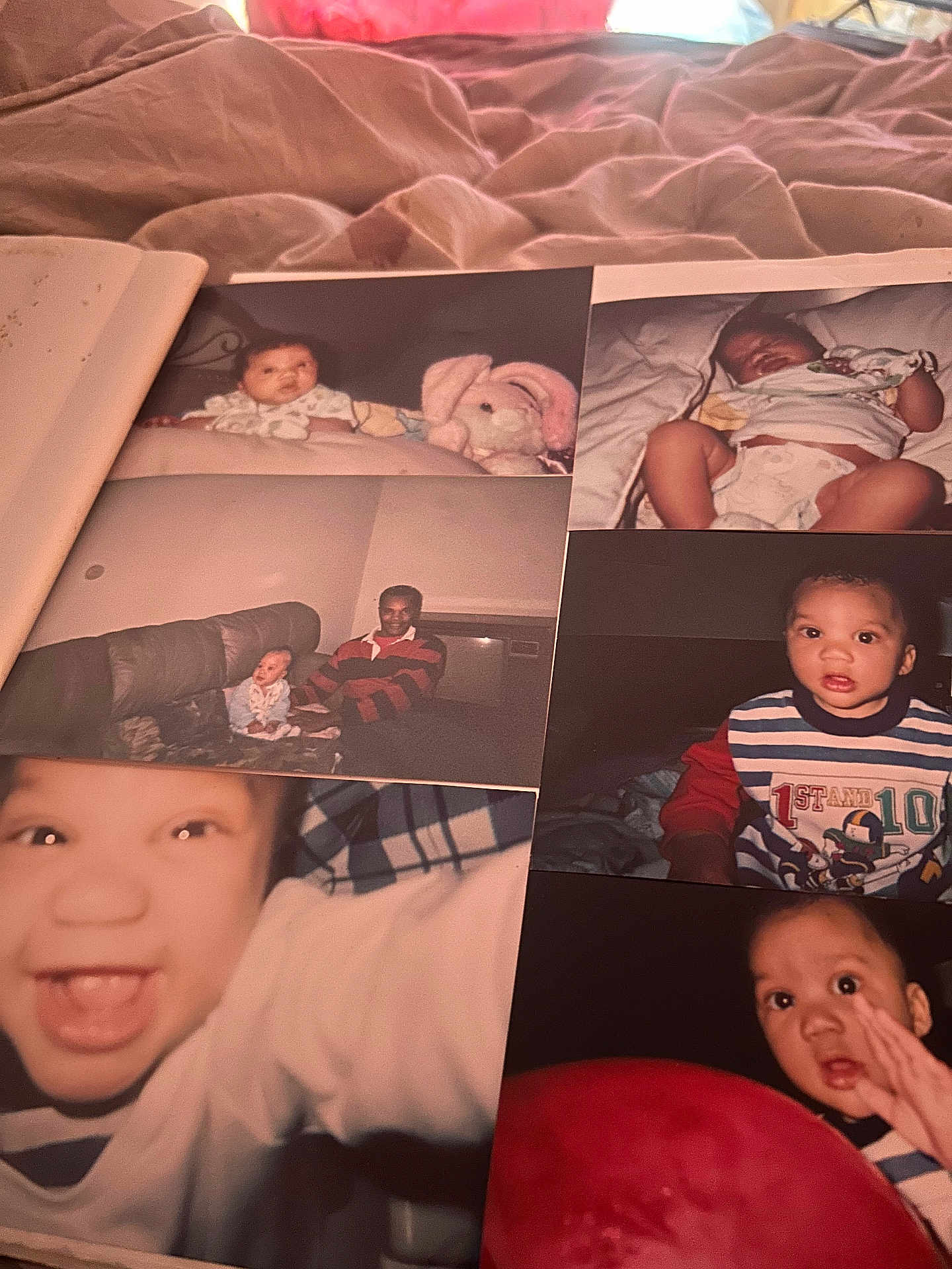 Winston Brown is registered to the contest to win money with this photo: baby, toddler, child, person, couch, plush_toy, adult, smile, close_up, indoor, photograph, bed, blanket, clothing, diaper, portrait, happy, family, nostalgia, album