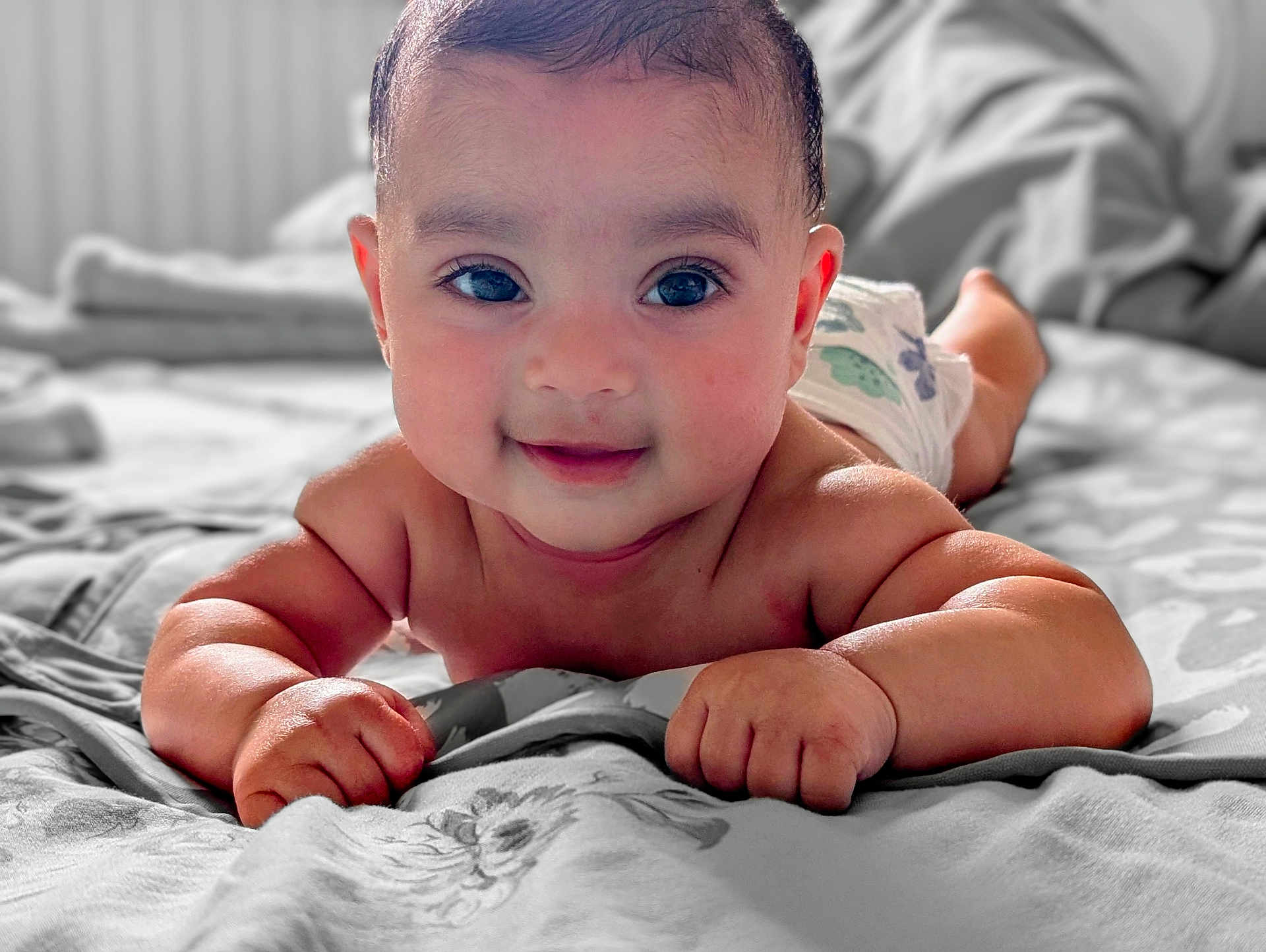 Aairah joined the competition — help win amazing prizes! baby, bed, child, closeup, cute, diaper, eyes, face, hand, happy, indoors, infant, lying_down, person, portrait, skin, smiling, soft_light, tummy_time, young