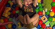 Lucas joined the competition — help win amazing prizes! ball_pit, balls, black_tshirt, casual_clothing, child, colorful, green_plush, happy, indoor, inflatable, orange_basketball, playpen, playtime, plush_toy, raised_arms, shorts, smiling, toddler, toys, wooden_blocks