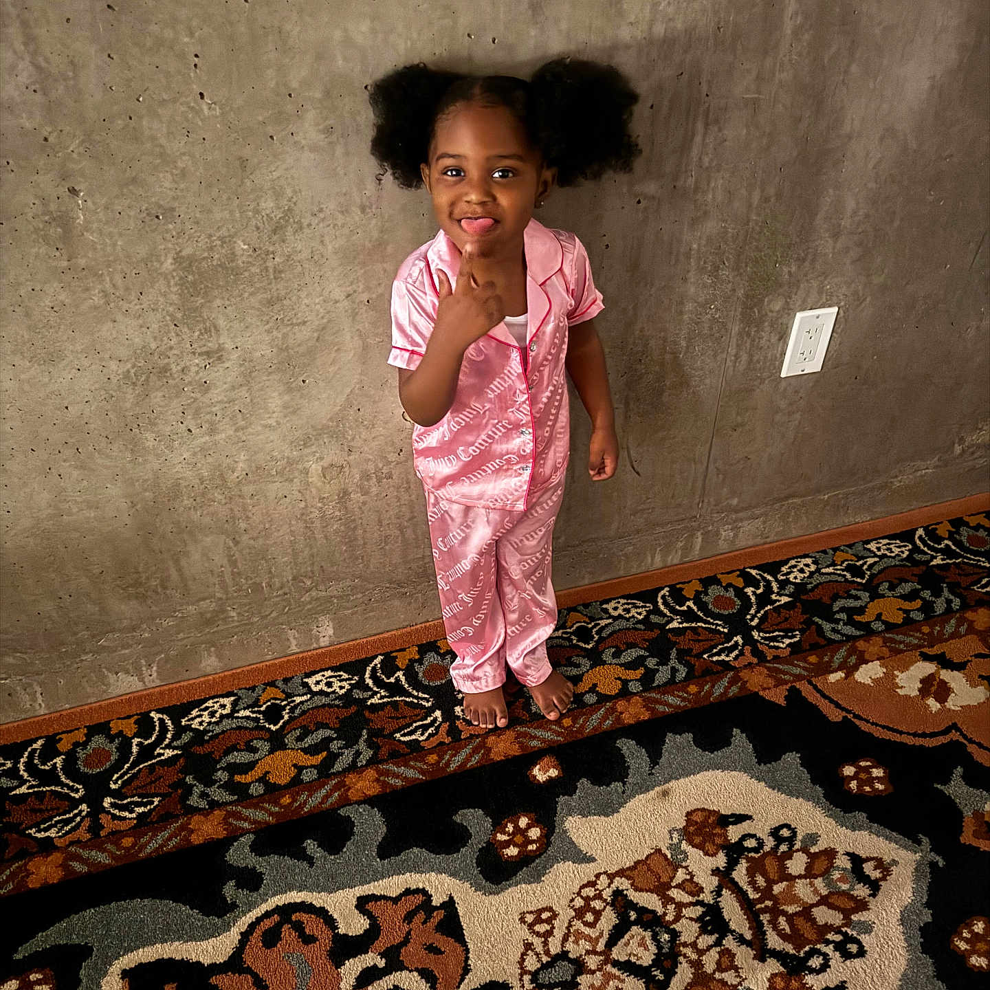 Covenant joined the competition — help win amazing prizes! barefoot, carpet, child, concrete_wall, cute, expression, floor, girl, hair_puffs, indoor, pajamas, patterned_rug, person, pink, playful, pointing, smiling, standing, tongue_out, wall_socket