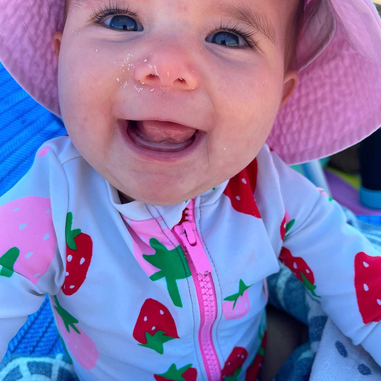 Parker is registered to the contest to win money with this photo: baby, bodypart, cap, clothing, coat, dress, face, happy, hat, head, jacket, laughing, mouth, person, photography, portrait, smile, summer, sunhat, teeth