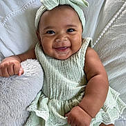 Kiara joined the competition — help win amazing prizes! baby, infant, child, smiling, portrait, indoors, bed, pillow, blanket, bow, headband, mint_green, dress, lace, clothing, sitting, happy, face, furniture, photography
