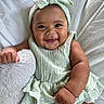 baby, infant, child, smiling, portrait, indoors, bed, pillow, blanket, bow, headband, mint_green, dress, lace, clothing, sitting, happy, face, furniture, photography