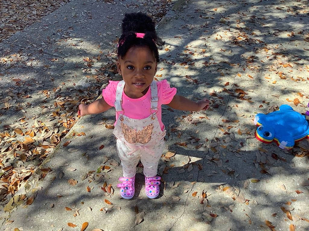 Eryn joined the competition — help win amazing prizes! baby_toddler_clothing, child, deciduous, fun, grass, happy, human_body, landscape, leisure, magenta, people_in_nature, person, play, sand, shadow, soil, sunlight, tints_and_shades, toddler, tree