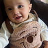 baby, child, infant, smiling, portrait, indoor, seated, teddy_bear, stuffed_animal, plush_toy, cuddling, white_clothing, brown, cozy, chair, close_up, face, happy, home, photography