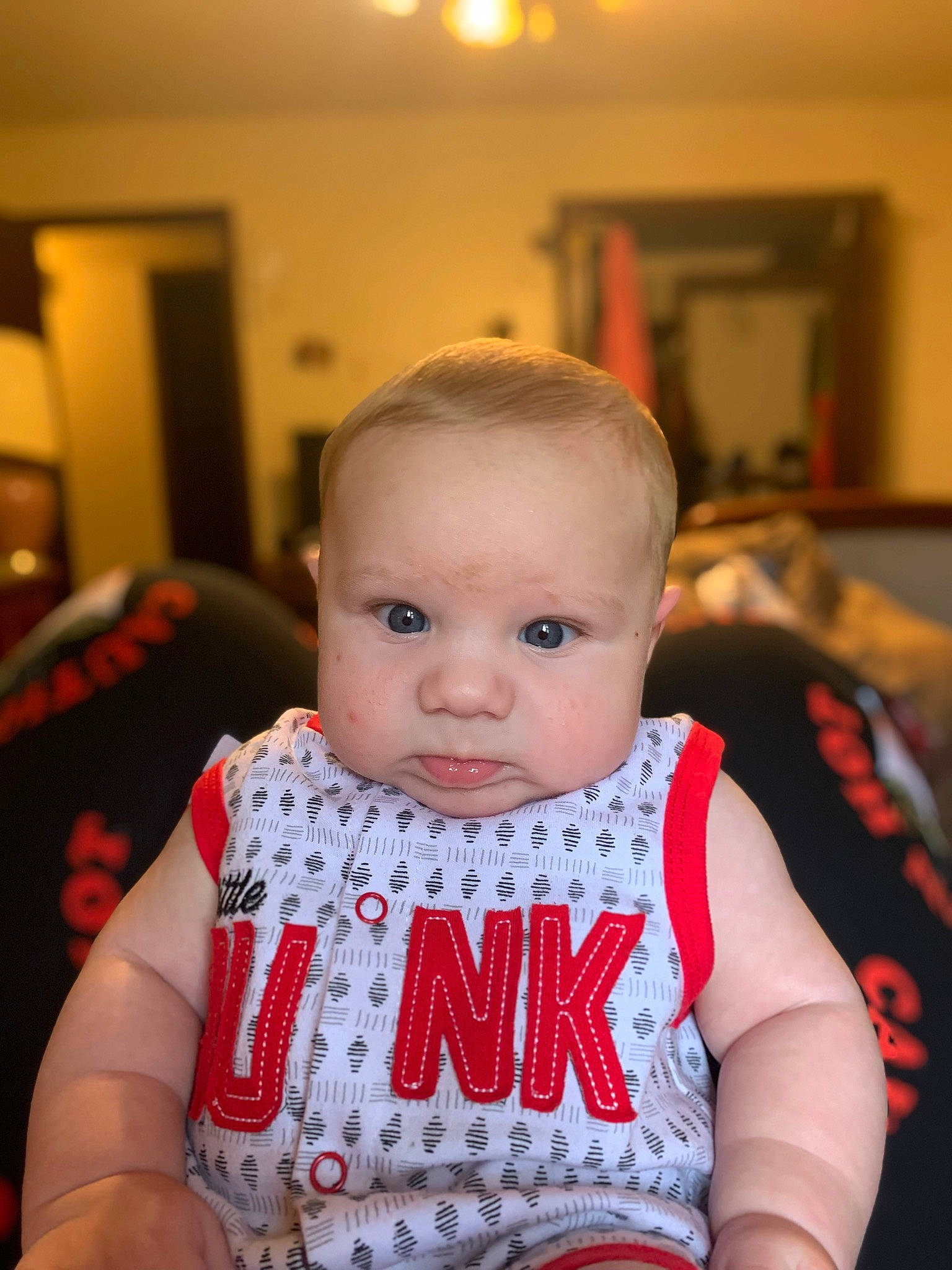 Kannon is registered to the contest to win money with this photo: baby, baby_products, baby_toddler_clothing, bib, chair, cheek, child, dress, event, eyelash, happy, iris, lip, person, picture_frame, room, sitting, skin, sleeve, t_shirt