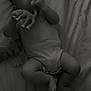 baby, infant, toy, giraffe, bed, sheet, clothing, onesie, hand, feet, face, lying_down, monochrome, soft_light, cute, child, indoor, sleepwear, play, portrait