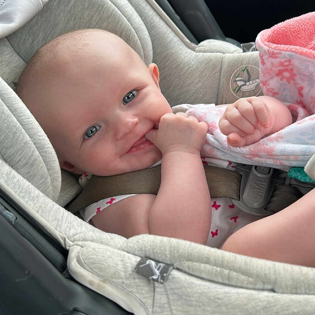 Harper joined the competition — help win amazing prizes! baby, car_seat, child, infant, blue_eyes, hand, blanket, car_interior, seatbelt, smiling, cute, comfort, clothing, sitting, young_child, safety, portrait, baby_girl, pink, soft