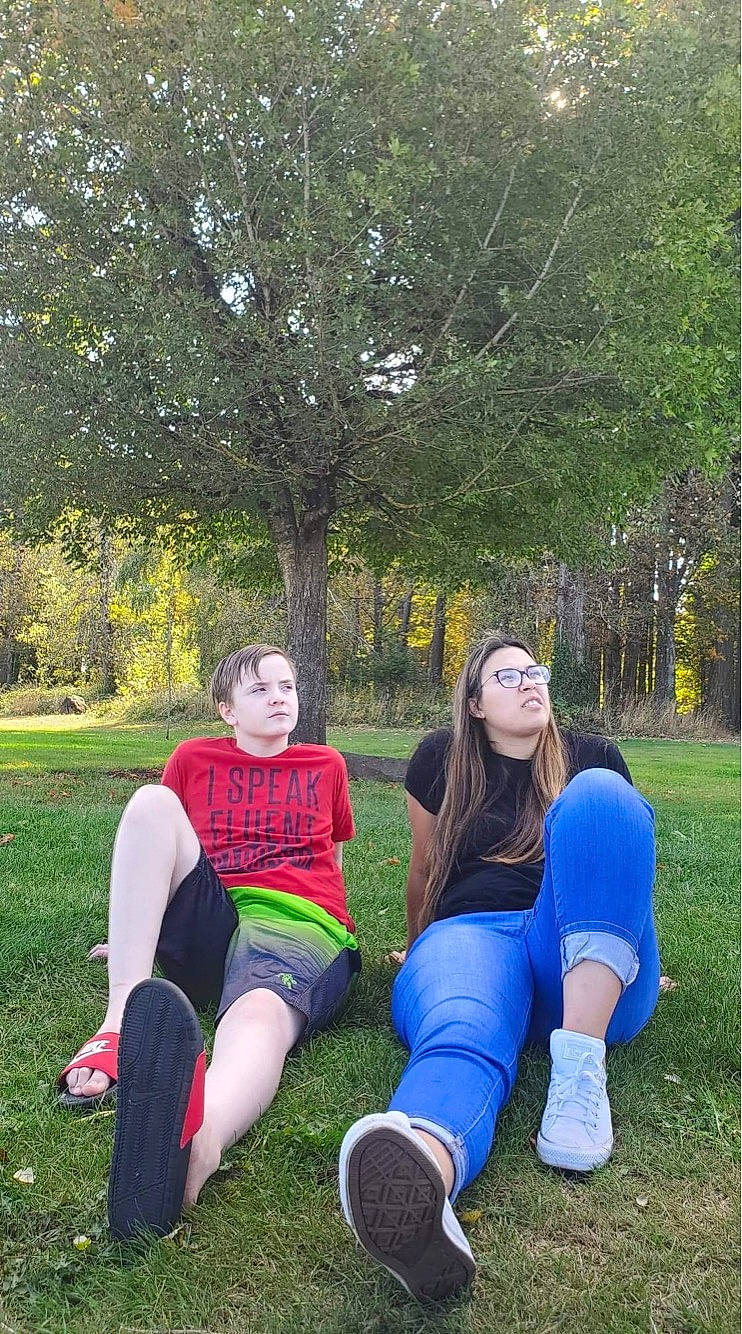 Shawn is registered to the contest to win money with this photo: family, fun, grass, lawn, leisure, park, person, photography, plant, recreation, sitting, spring, team, tree, vacation