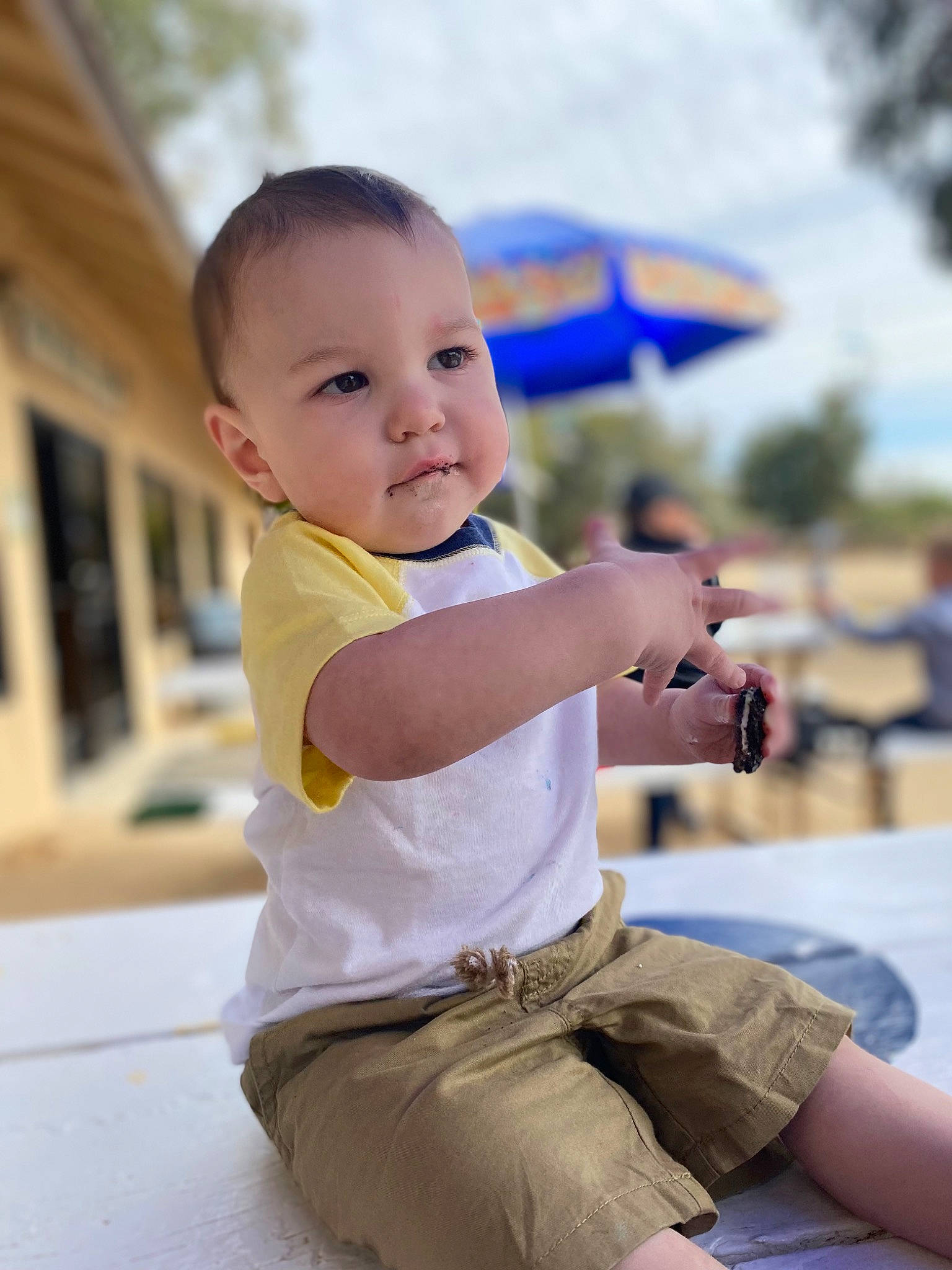 Dezmond is registered to the contest to win money with this photo: child, fun, hairstyle, happy, joint, knee, leisure, person, recreation, shorts, sitting, skin, sky, smile, summer, t_shirt, thigh, toddler, travel, tree