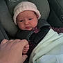 baby, infant, car_seat, graco, blanket, knit_hat, hand, holding, purple_clothing, polka_dots, child, young, cute, human, face, expression, indoor, person, safety_harness, blanket_edge