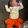 baby, sleeping, pacifier, orange_tutu, orange_pants, white_shirt, ghost_print, cozy, blanket, soft_toys, cute, infant, child, indoors, resting, peaceful, clothing, footwearless, lying_down, toddler