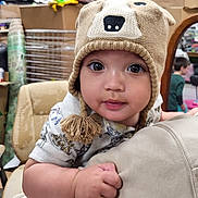 Axel joined the competition — help win amazing prizes! baby, child, hat, knitted_hat, bear_hat, indoor, person, mirror, reflection, boxes, furniture, arm, clothing, cute, face, hand, holding, expression, large_eyes, toddler