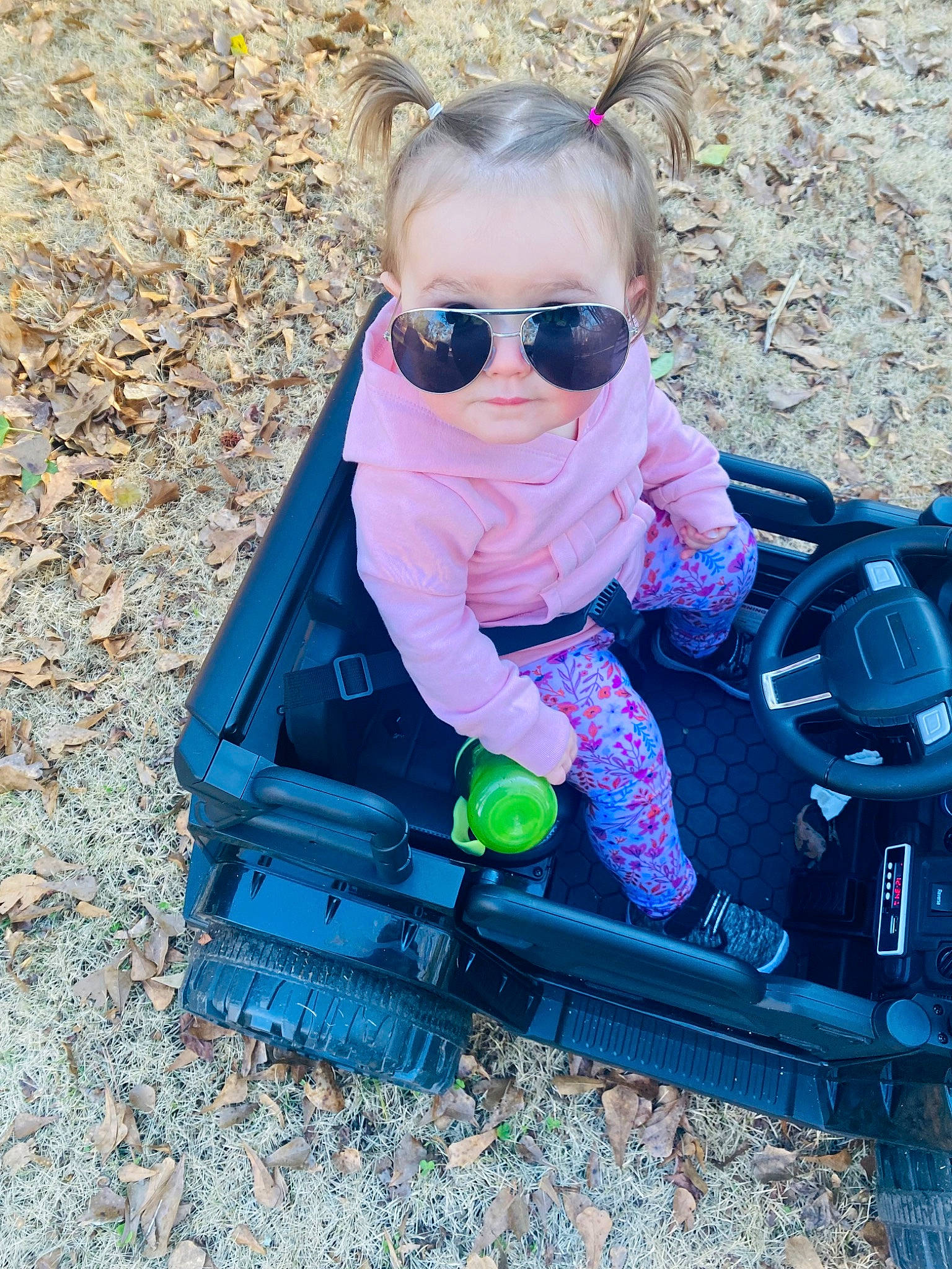 Arya is registered to the contest to win money with this photo: baby, baby_products, baby_toddler_clothing, child, electric_blue, eyewear, fun, glasses, goggles, grass, leisure, magenta, person, personal_protective_equipment, play, recreation, sitting, smile, sunglasses, toddler