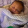 Jaylen is registered to the contest to win money with this photo: baby, sleeping, blanket, pacifier, infant, cozy, soft, closeup, face, child, cute, rest, comfort, indoor, patterned_background, newborn, peaceful, warm, wrapped, toddler