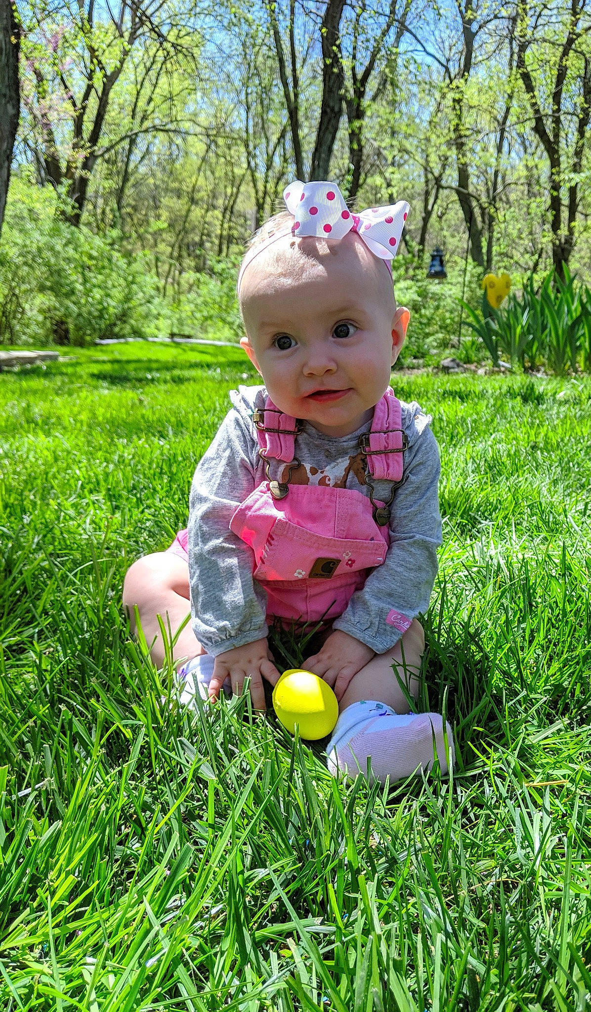 Annabelle is registered to the contest to win money with this photo: baby, child, easter, easter_egg, grass, grass_family, headwear, meadow, person, plant, play, sitting, spring, toddler