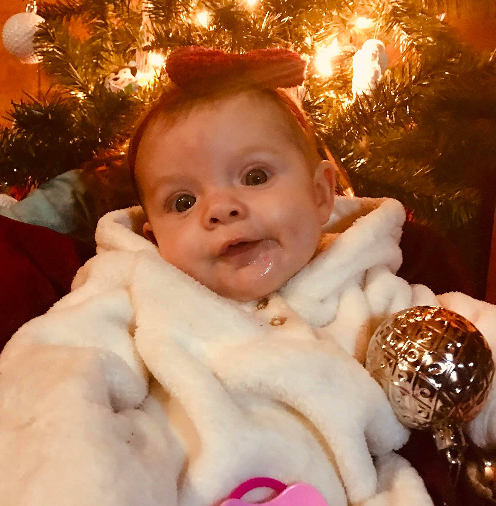 Worthy Grace is registered to the contest to win money with this photo: baby, baby_toddler_clothing, baked_goods, cheek, child, christmas, christmas_decoration, christmas_eve, christmas_lights, christmas_ornament, christmas_tree, dessert, fur, happy, holiday, holiday_ornament, lip, ornament, person, pleased