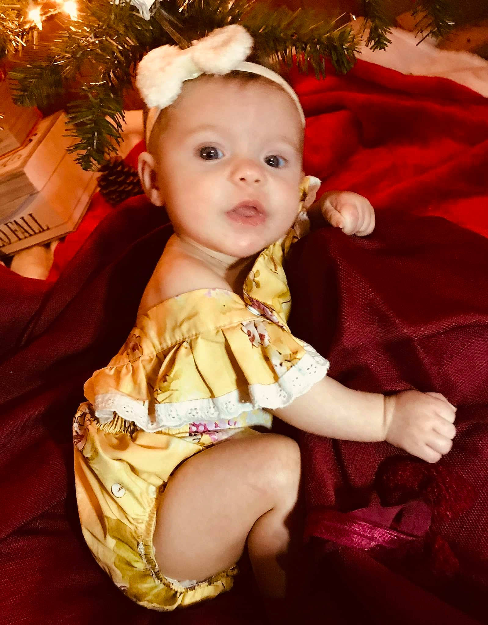 Worthy Grace is registered to the contest to win money with this photo: baby, baby_toddler_clothing, christmas, christmas_decoration, christmas_eve, christmas_lights, christmas_ornament, christmas_tree, conifer, costume_accessory, costume_hat, embellishment, fictional_character, fir, holiday, holiday_ornament, ornament, person, pine, pine_family