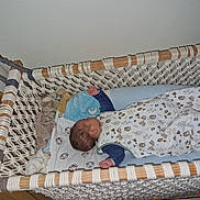 Mael Valentim participe au concours pour gagner de l'argent avec cette photo : baby, crib, hammock, sleeping, blanket, plush_toy, wood, rope, infant, sleepwear, bedroom, child, rest, comfort, fabric, soft_toy, nap, peaceful, indoors, cozy