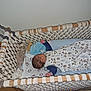 baby, crib, hammock, sleeping, blanket, plush_toy, wood, rope, infant, sleepwear, bedroom, child, rest, comfort, fabric, soft_toy, nap, peaceful, indoors, cozy