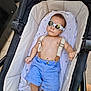 Mael Valentim a rejoint le concours — aidez-le/la à gagner de superbes lots ! baby, stroller, sunglasses, blue_shorts, suspenders, infant, clothing, reflection, person, footwear, blanket, relaxed, outdoor, cute, fashion, baby_clothes, skin, head, hand, feet