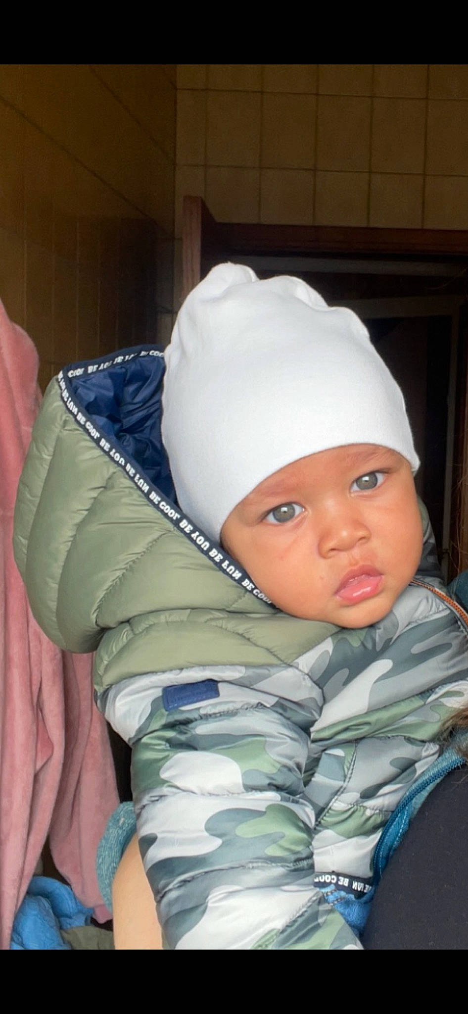 Nolan participe au concours pour gagner de l'argent avec cette photo : baby, baby_products, baby_sleeping, baby_toddler_clothing, beanie, cap, cheek, child, comfort, fashion_accessory, headgear, headwear, knit_cap, linens, pattern, person, room, sitting, sleeve, textile
