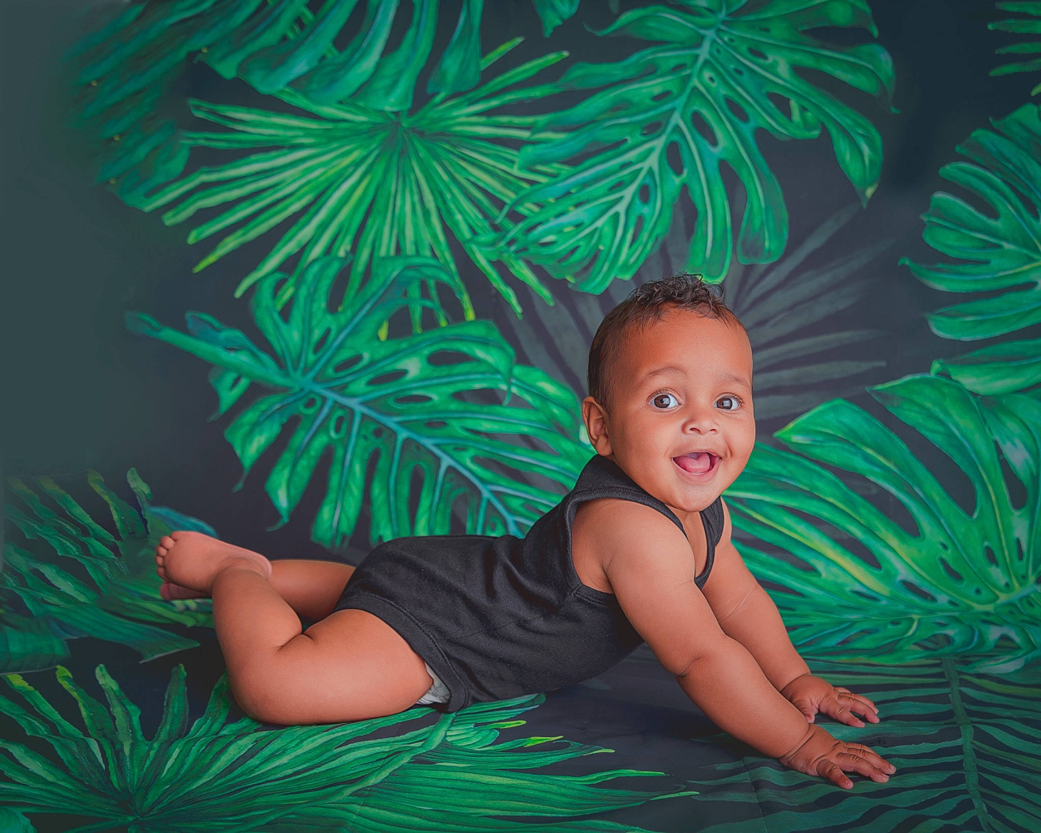 Cassius is registered to the contest to win money with this photo: aqua, botany, event, eye, flash_photography, grass, green, happy, joy, leaf, mammal, nature, organism, pattern, people_in_nature, person, plant, smile, terrestrial_plant, toddler