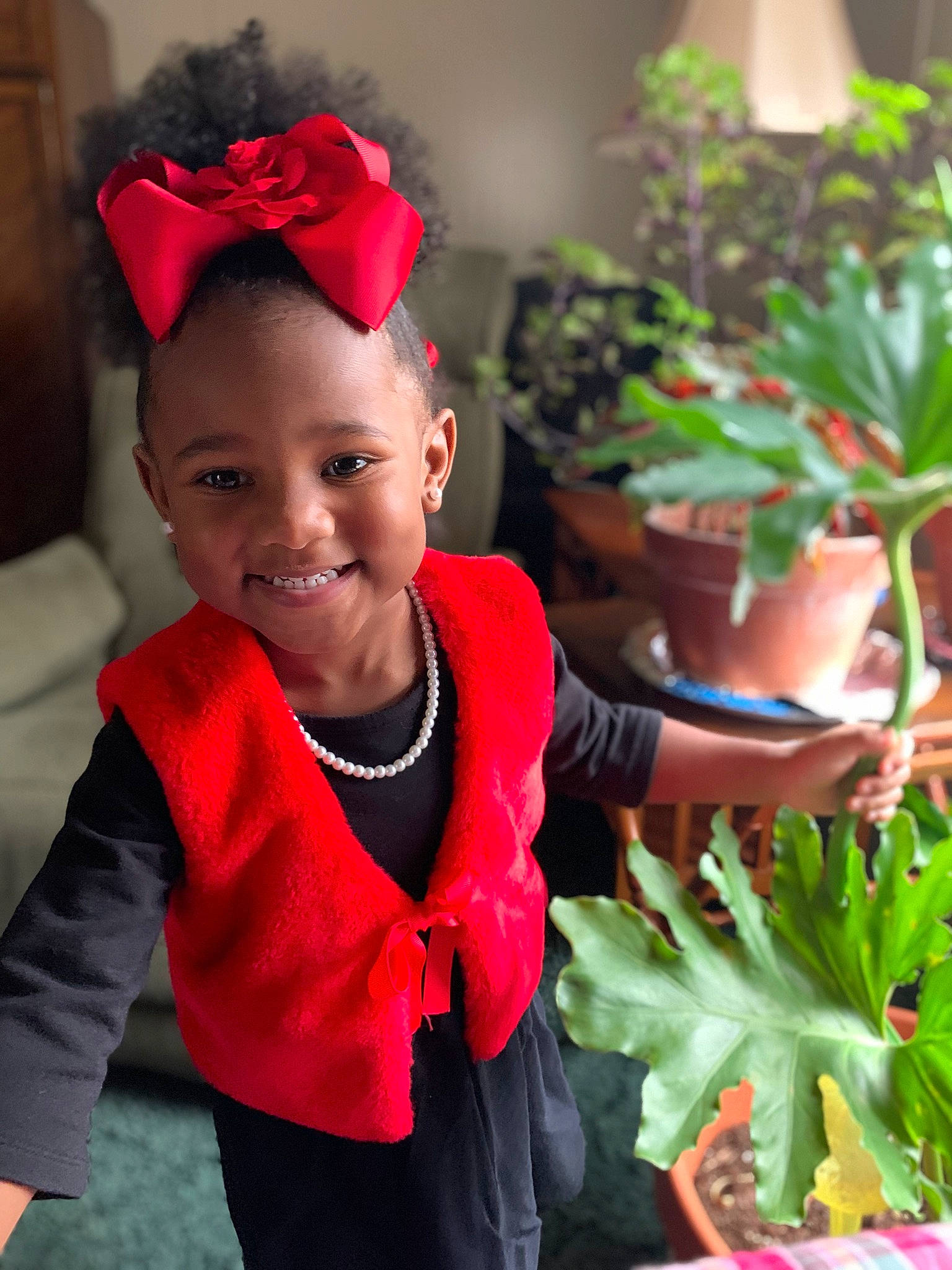 Nayeli joined the competition — help win amazing prizes! baby, baby_toddler_clothing, cap, costume_hat, event, face, flowerpot, fun, grass, happy, houseplant, joy, leaf, leaf_vegetable, magenta, natural_foods, person, pink, plant, red