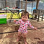 Mia joined the competition — help win amazing prizes! toddler, child, swimsuit, strawberry_pattern, outdoor, patio, sunlight, canopy, wet_hair, barefoot, table, cooler, fence, grass, backyard, playful, person, summer, concrete, young_child