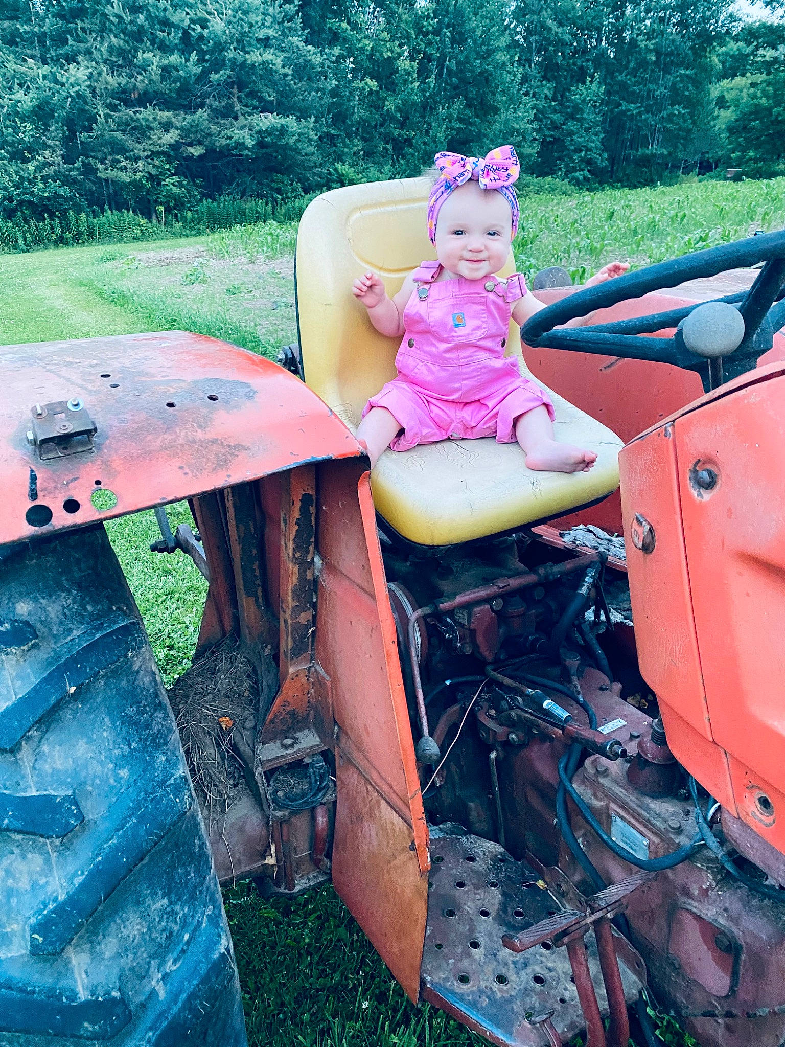 Charlotte is registered to the contest to win money with this photo: auto_part, automotive_design, automotive_exterior, automotive_lighting, automotive_tire, automotive_wheel_system, bumper, chair, classic, fender, grass, headwear, joy, leisure, magenta, motor_vehicle, person, pink, plant, tints_and_shades