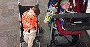 Bryant joined the competition — help win amazing prizes! toddler, baby, stroller, indoor, child, toy, blanket, carpet, hat, clothing, shoes, floor, person, seated, sleeping, curious, wheelchair, comfort, cute, nursery